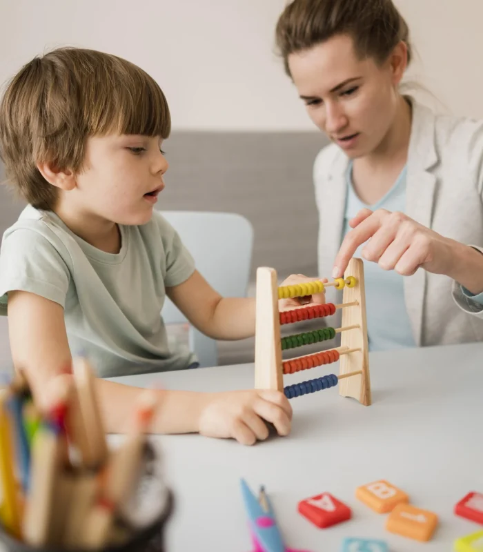 side-view-tutor-teaching-child-how-use-abacus.jpg